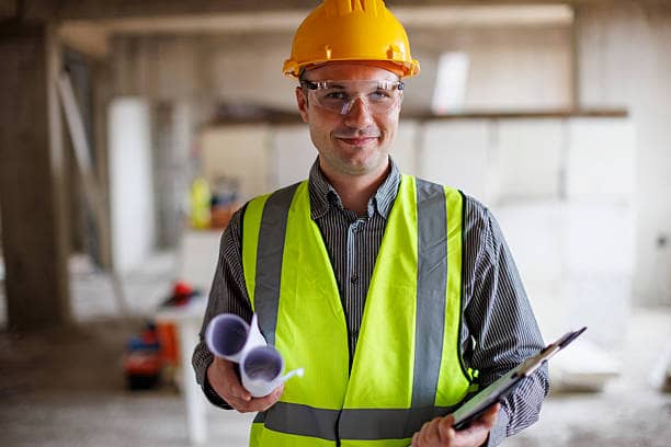 Surveyor assessing internal building condition and identifying defects
