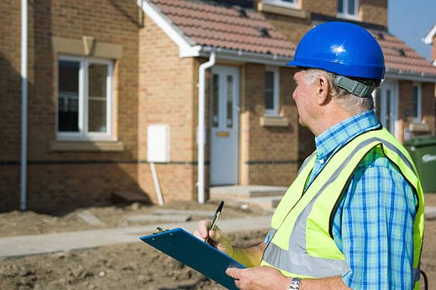 Surveyor identifying finishing defects during new build inspection